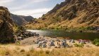 Group campsite on a sandy beach along the Snake River between Idaho and Oregon on a sunny summer day