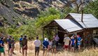 Group of people exploring a pioneer homestead while on a whitewater rafting trip on the Snake River through Hells Canyon