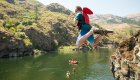 A kid cliff jumping on a guided rafting tour in Idaho
