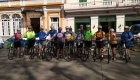Group picture of bikers off their bikes on a busy street in Havana