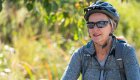 Close up of a woman wearing a bike helmet and sunglasses