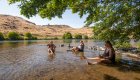 rafters sitting in the water along the Deschutes River