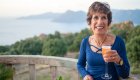 A guest enjoys an evening aperitif overlooking the Corsican coastline, a relaxed cultural moment on a small-group Corsica tour.