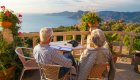 couple overlooking ocean from balcony in corsica
