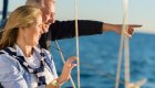 couple looking off deck of yacht