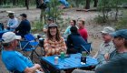 people relaxing at tables in rafting camp on salmon river