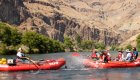 Rafters splashing each other with paddles on the Deschutes River