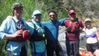 team of river guides standing arm in arm