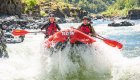 people in red raft on the rogue river