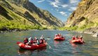A group of rafts on the Snake River in Hells Canyon on a sunny day