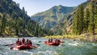 Two rafts floating through a scenic canyon stretch of the river.