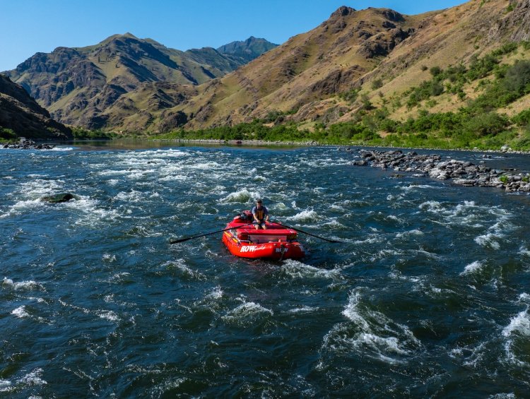 Group of people whitewater rafting through rapids on a guided river trip, an exciting short vacation idea for adventure travel in the Pacific Northwest.