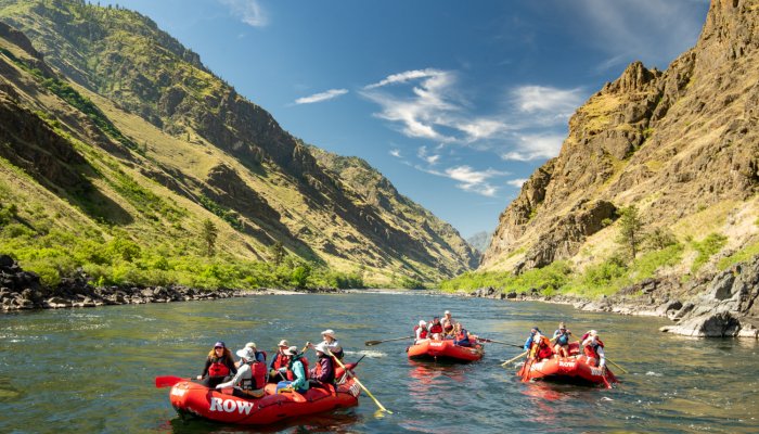 Red rafts floating on the snake river in Hells Canyon Idaho